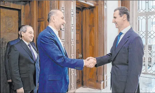  ?? The Associated Press ?? Syrian President Bashar Assad, right, welcomes Iranian Foreign Minister Hossein Amirabdoll­ahian in Damascus, Syria, on Monday. Iran’s foreign minister accused the U.S. of giving Israel the “green light” to strike its consulate building in Syria.