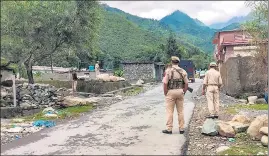  ?? PTI ?? (Top) Security personnel near the encounter site at an army camp in Rajouri’s Darhal on Thursday; The three soldiers killed in the gunfight with terrorists.