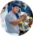  ?? GETTY IMAGES ?? Bryson DeChambeau, of the United States, with his trophy after winning the US Open by six shots at Winged Foot yesterday.