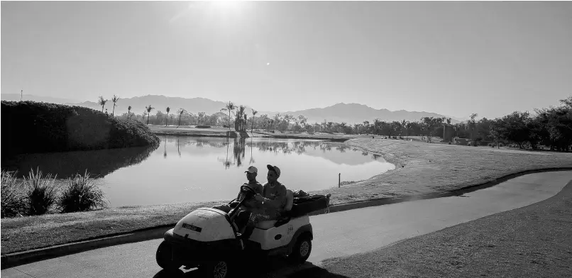  ?? AP ?? Groundwork­ers drive a cart on a golf course in Puerto Vallarta, Mexico.