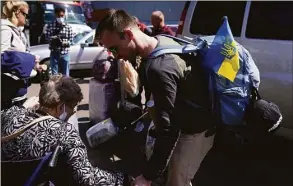  ?? Gregory Bull / Associated Press ?? A group of Ukrainians arrives at a shelter on April 21 in the border city of Tijuana, Mexico. The Biden administra­tion is making it easier for refugees fleeing Russia’s war on Ukraine to come to the United States from Europe while trying to shut down an informal route through northern Mexico that has emerged in recent weeks.