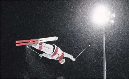  ?? CAMERON SPENCER GETTY IMAGES ?? Mikael Kingsbury soars to his first gold medal in Olympic moguls Monday, making it three straight for Canada.