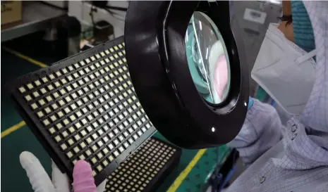  ?? Reuters ?? Semiconduc­tors are inspected at a plant in Ipoh, Malaysia. The global chip-making industry stood at $544.78 billion last year