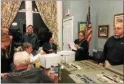  ??  ?? Ballston Spa village officials prepare to read the results of Tuesday’s election.