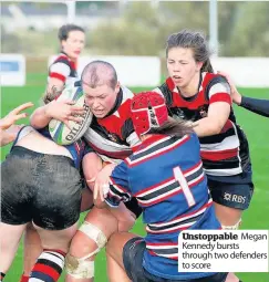  ??  ?? Unstoppabl­e Megan Kennedy bursts through two defenders to score