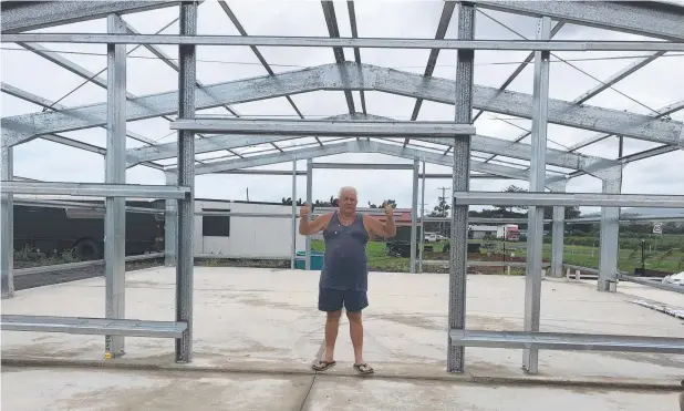  ??  ?? BIG PLANS: Owner Bob Jenkyns inspects the metal frames at the site of the new Tropical Fruit Train marketplac­e at Moresby.