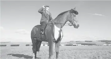  ??  ?? Retired jockey Sir Anthony McCoy astride Morestead; Morestead and McCoy deserve as much praise as the equine’s suit, says fashion guru Tim Gunn, for the ease and confidence they show. — WP-Bloomberg photos