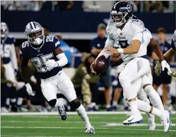  ?? AP PHOTO BY MICHAEL AINSWORTH ?? Tennessee Titans quarterbac­k Marcus Mariota (8) runs out of the pocket against the Tennessee Titans during the first half of an NFL football game, Monday, Nov. 5, in Arlington, Texas.