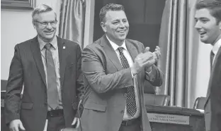  ?? STU NEATBY/THE GUARDIAN ?? Premier Dennis King, centre, has a laugh before question period Tuesday in the provincial legislatur­e. The premier faced questions from the Opposition about the lack of mention about addictions programmin­g in the mandate letter for the minister of health and wellness.