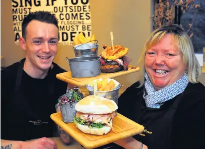  ?? Pictures: Mark Watkins ?? Chef Sam Steer and owner Tania Marley with the Beef it Up British and Barking Boris Brexit Burgers at The Halfway House near Guiting Power