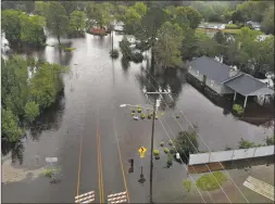  ?? Joe Raedle / Getty Images ?? Flood waters from Hurricane Florence surround a house and flow along the street on Sunday in Fayettevil­le, N.C. Rain continues to inundate the region causing concern for large scale flooding in the North Carolina and South Carolina area. The storm has been downgraded to a tropical depression.