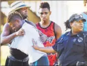  ?? AP ?? People embrace after a fatal shooting at Club Blu in Fort Myers, Florida, on Monday.