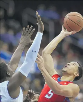  ??  ?? DePaul’s Billy Garrett Jr. shoots over Seton Hall’s Angel Delgado during the first half Saturday. Garrett scored 22 points on 8- for- 11 shooting in the Blue Demons’ loss.
| AP