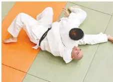 ??  ?? Judokas practice judo techniques.