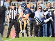  ?? Stew Milne / Associated Press ?? UConn’s Jay Rose dives for a touchdown against Wyoming on Saturday.