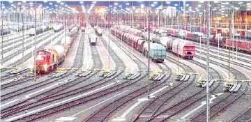  ??  ?? Cargo trains stand on the rails at the central station in Halle (Saale), eastern Germany, during a warning strike of railworker­s. — AFP photo