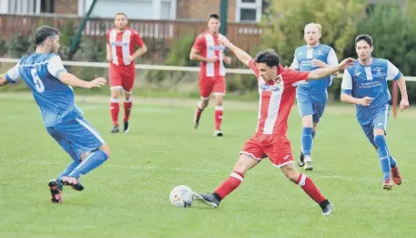  ??  ?? Ryhope CW’s Shaun Pickford (red and white) attempts to evade a Dunston UTS tackle. Pictures by Stu Norton.