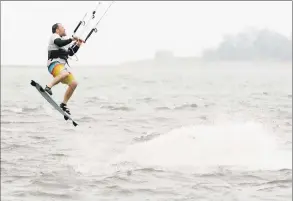  ?? Erik Trautmann / Hearst Connecticu­t Media ?? Wind and kite surfers take to the waters off Calf Pasture Beach to take advantage of the high winds brought by a tropical storm on Friday in Norwalk.