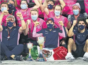  ?? PETER FOX GETTY IMAGES ?? Race winner Sergio Perez of Mexico and his Racing Point teammate Lance Stroll of Canada, who finished third, celebrate with team members after the Grand Prix of Sakhir on Sunday.