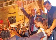  ?? (AFP) ?? Newly-elected Turkish Cypriot President Ersin Tatar (centre) celebrates with supporters after winning the presidenti­al election on Sunday