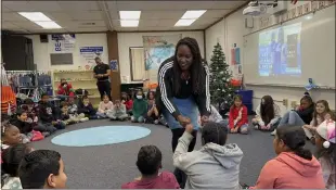  ?? COURTESY OF CLAY COUNSELING FOUNDATION ?? At rear left, Tawon Green, assistant director of the Clay Counseling Foundation; and April Clay, CEO of the Clay Counseling Foundation; work with students.