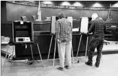  ?? MICHAEL CONROY/AP ?? Voters prepare their ballots last month during early voting in Indiana, one of four states with primaries on Tuesday.