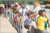  ??  ?? Parents and family members help children practice lining up at Mary H. Matula Elementary School as part of the La Plata branch library’s “Hop on the Bus” program Thursday morning.