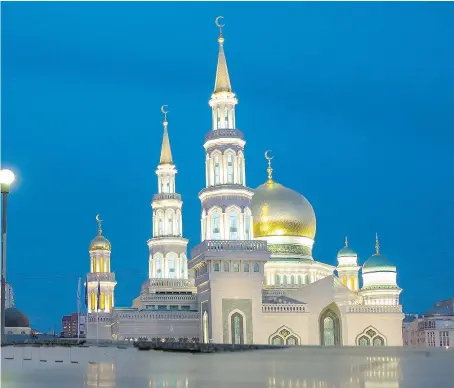  ?? — PHOTOS: THE ASSOCIATED PRESS ?? The minarets of the Moscow Cathedral Mosque rise next to a sports arena built for the 1980 Moscow Olympics in Moscow, Russia.