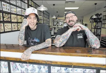  ?? K.M. Cannon Las Vegas Review-journal ?? Franco Adonis, left, and Pete Mills, who call themselves tattooers, pose at Last Love Tattoo Parlour in Las Vegas Thursday, ahead of their Friday the 13th promotion.