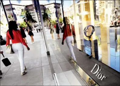  ?? AP/RICHARD VOGEL ?? Shoppers walk past a Dior luxury goods shop on Rodeo Drive in Beverly Hills, Calif., in April. Overall consumer prices edged up 0.1 percent in April, the Labor Department said Friday.