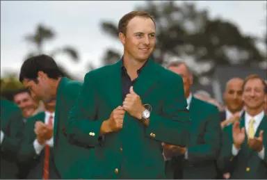  ?? David J. Phillip/AP ?? Jordan Spieth wears his green jacket after winning the Masters golf tournament Sunday, April 12, 2015, in Augusta.
