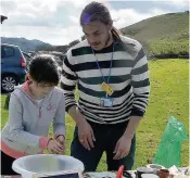  ??  ?? Alistair Hanak making seed bombs with Catherine Anson