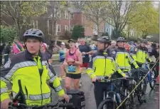  ?? SCREENSHOT FROM JEAN MIKE REMY VIDEO ?? A group of Newton police officers with bicycles lined up at a running group’s spot on Marathon Monday, restrictin­g their cheering access to the road.