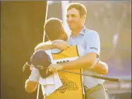  ?? Cliff Hawkins / Getty Images ?? Brendon Todd celebrates with his caddie on the 18th green after winning during the continuati­on of the final round of the Mayakoba Golf Classic at El Camaleon Mayakoba Golf Course on Monday in Playa del Carmen, Mexico.