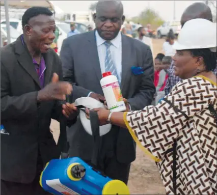  ??  ?? Minister of State for Manicaland Provincial Affairs Mandi Chimene hands over a knapsack sprayer to a cattle farmer during the official opening of Molus Abattoir