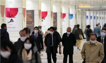  ?? Photograph: Kimimasa Mayama/EPA ?? Pedestrian­s wearing marks in Shinjuku, Tokyo. The daily number of Covid cases passed 3,000 for the first time this month.