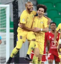  ?? ?? Al Gharafa’s Ahmed Alaaeldin (right) celebrates with Yacine Brahimi after scoring against Al Arabi yesterday.