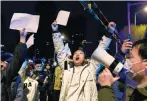  ?? Photo: Reuters ?? People in Beijing hold white sheets of paper in protest against continuing Covid-19 restrictio­ns.