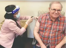  ?? ALBERTA HEALTH SERVICES ?? Mario Saraceni, 73, becomes the first long-term care resident in Calgary to receive the Moderna vaccine. Inoculatio­ns of the general public aren't expected until this fall.