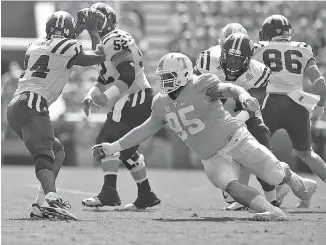  ?? STAFF PHOTO BY ROBIN RUDD ?? Tennessee defensive tackle Danny O’Brien pressures Ohio quarterbac­k Greg Windham during their game earlier this month at Neyland Stadium. O’Brien and fellow tackle Kendal Vickers have been reliable veterans for the Vols this season.