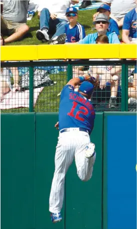  ?? AP ?? Schwarber ( failing to make a catch during spring training) had a tough time with a fly ball that turned into a triple and let another ball skip past him for an error Thursday.