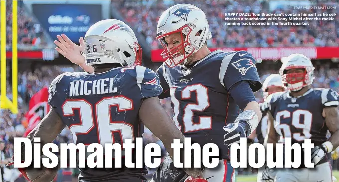  ??  ?? HAPPY DAZE: Tom Brady can’t contain himself as he celebrates a touchdown with Sony Michel after the rookie running back scored in the fourth quarter.