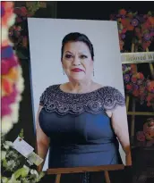  ??  ?? A photo of Arcelia Martinez, who died of coronaviru­s a year ago, is displayed during a memorial service at Lima Family Erickson Memorial Chapel in San Jose.