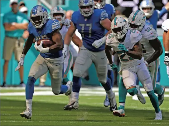  ?? JOHN MCCALL/SUN SENTINEL PHOTOS ?? Detroit Lions running back Kerryon Johnson runs away with the ball for a big gain against the Miami Dolphins in the first half on Sunday at Hard Rock Stadium in Miami Gardens.