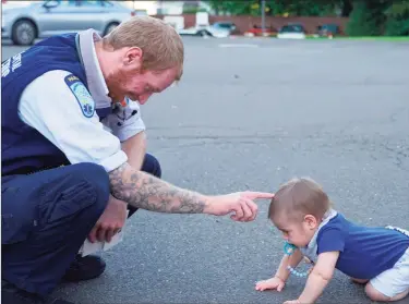  ?? Grace Duffield / Hearst Connecticu­t Media ?? Dan Bach met 15-month old Ryan Martin for the second time behind the EMS building on South Avenue in New Canaan on Sept. 24 when his parents, Angela and Peter Martin, came to thank Bach for saving their child’s life.