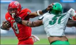  ?? L.E. Baskow
Las Vegas Review-journal @Left_eye_images ?? UNLV running back Aidan Robbins looks to keep the Fresno State defense at arm’s length on Friday. Robbins had 115 yards rushing last week in his return from an injury.