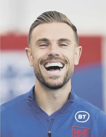  ??  ?? 0 Jordan Henderson in good spirits as he chats to the media yesterday at St George’s Park