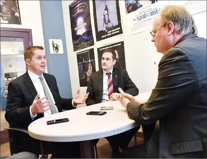  ?? DENIS DREVER/Special to Okanagan Weekend ?? Federal Conservati­ve leader Andrew Scheer, left, speaks with Okanagan Newspaper Group valley editor James Miller, right, in Miller’s Penticton office, Wednesday. Looking on is Central Okanagan-Similkamee­n-Nicola member of Parliament Dan Albas.