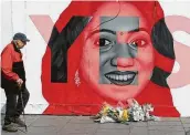  ?? Niall Carson / Associated Press ?? A pro-repeal mural in Dublin depicts Savita Halappanav­ar, a 31-year-old Indian dentist who had sought and been denied an abortion before she died after having a miscarriag­e in a Galway hospital.