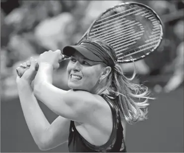  ?? KATHY WILLENS/AP PHOTO ?? Maria Sharapova follows through with a backhand return during her 6-4, 4-6, 6-3 upset of second-seeded Simona Halep in the opening round of the U.S. Open women’s tennis tournament on Monday night in New York.